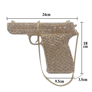 Detail view of crystal-encrusted gun-shaped evening bag with size measurements