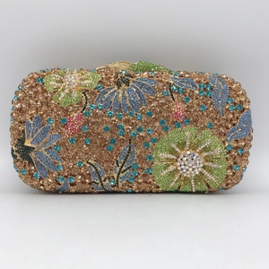 Detailed view of floral crystal pattern and sparkling rhinestones on evening clutch bag