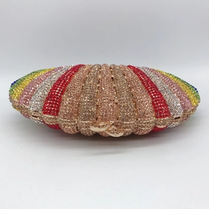 Detailed close-up of rainbow gradient crystals on a shell-shaped evening clutch bag