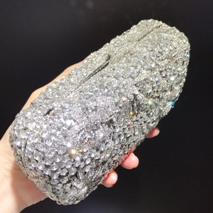 Close-up of luxury silver floral clutch bag with sparkling crystals and metal clasp
