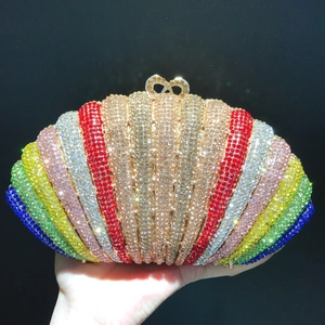 Close-up of rainbow rhinestone shell evening bag with elegant bow-shaped metal clasp