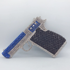 Detailed view of rhinestone handgun clutch featuring blue, white, and black crystals