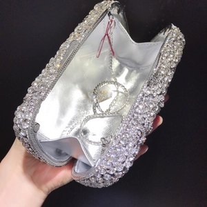 Close-up of sparkling silver floral evening clutch bag with diamonds and chain strap