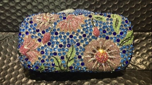 Detail of floral crystal evening clutch with blue, pink, and green rhinestones