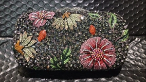 Detailed view of luxury floral evening clutch with colorful hand-set crystals and rhinestones