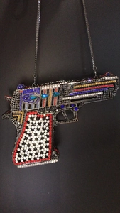 Detailed macro view of colorful rhinestones on a pistol shaped clutch evening bag