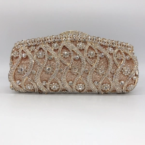 Close-up of champagne gold evening clutch featuring intricate floral rhinestone patterns
