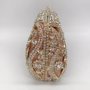 Close-up of sparkling crystals and rose gold metal frame on pear-shaped evening bag