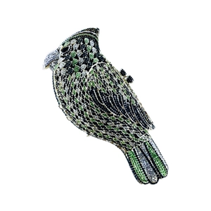 Detailed macro view showing the intricate green and black rhinestones on bird clutch bag