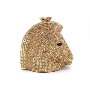 Detailed close-up of a luxury horse head clutch bag encrusted with sparkling gold crystals