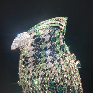 Exquisite bird-shaped evening clutch bag encrusted with green and white crystals