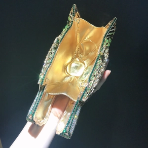 Detail of owl clutch bag interior with gold chain strap and sparkling crystals