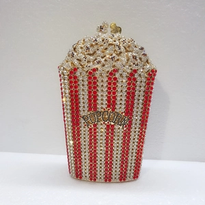 Detailed view of the luxury popcorn bucket evening bag with red and white crystal rhinestones