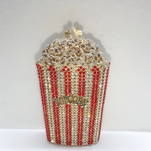Detail of a popcorn-shaped clutch bag with luxury red and white crystal embellishments