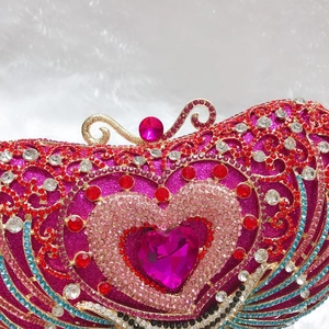 Macro detail of luxury evening clutch showing heart pattern and colorful crystal rhinestones