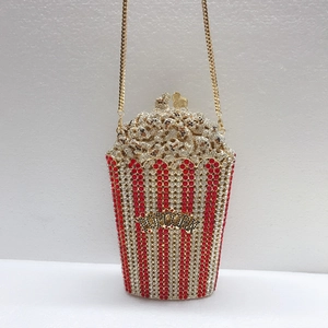 Detailed macro view of the popcorn clutch bag with red and white inlaid crystals