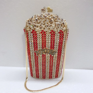 Detailed close-up of a popcorn-shaped evening clutch bag with red and white rhinestones