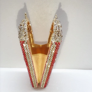 Detailed view of fish-shaped evening clutch bag with red and white crystal embellishments