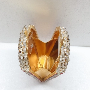 Top view of open heart-shaped evening clutch with crystal inlay and gold chain