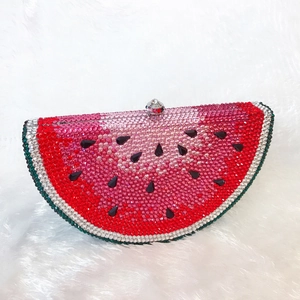 Detail of crystal watermelon clutch showing hand-set rhinestones and silver metal clasp