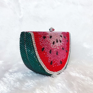 Macro detail of watermelon-shaped crystal clutch showing green rind and red pulp rhinestones