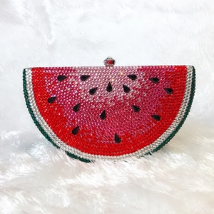 Detailed view of watermelon crystal evening bag with green and red rhinestone inlay