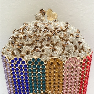 Macro shot of cupcake-shaped evening bag featuring rainbow rhinestones and heart clasp