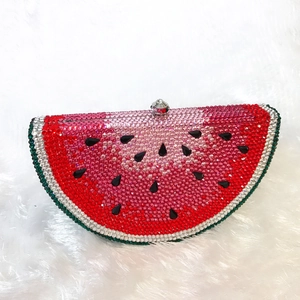 Macro detail of watermelon-shaped evening clutch with sparkling red and green crystals
