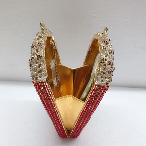 Detailed interior of rhinestone evening bag with gold lining, showing mobile phone capacity