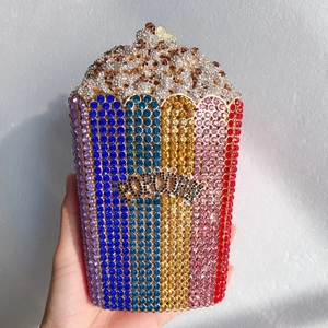 Macro detail of popcorn evening bag showing vibrant colorful rhinestones and gold clasp
