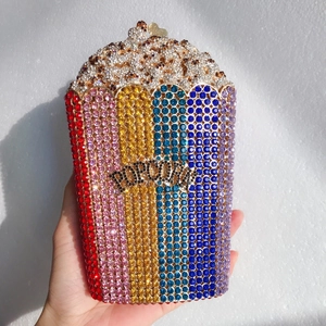 Detail of hand-held popcorn evening clutch with colorful rhinestones and metal latch