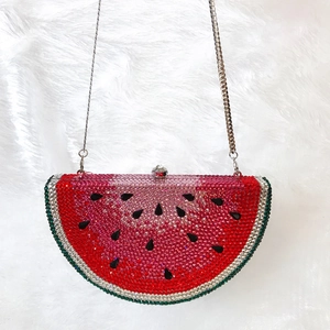 Detail of crystal watermelon evening clutch bag with sparkling rhinestones and chain strap