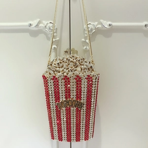 Detailed close-up of crystal popcorn evening bag with red and white rhinestone stripes