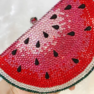 Macro shot of sparkling crystal watermelon clutch evening bag with metal clasp detail