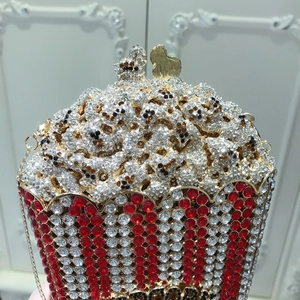 Macro shot of popcorn-shaped clutch bag with luxury rhinestones and gold chain
