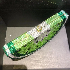 Detailed view of watermelon crystal evening clutch with sparkling rhinestones and gold clasp
