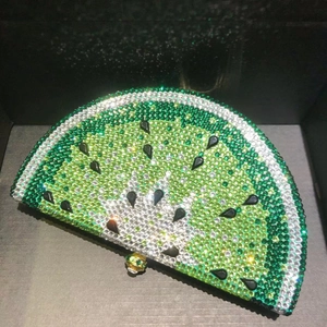 Close-up of watermelon crystal evening clutch featuring green rhinestones and gold clasp