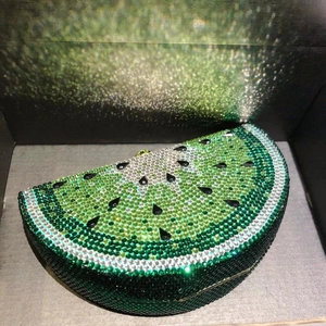 Macro shot of watermelon-shaped evening clutch bag with sparkling green rhinestones