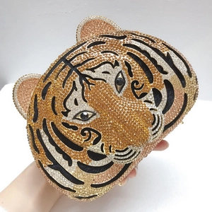 Detailed macro view of the crystal-encrusted tiger head clutch evening bag