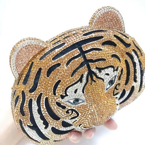 Detailed view of luxury tiger head evening bag with sparkling yellow and black crystals