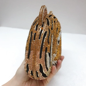 Detail of tiger head evening clutch bag featuring intricate leopard crystal encrusting