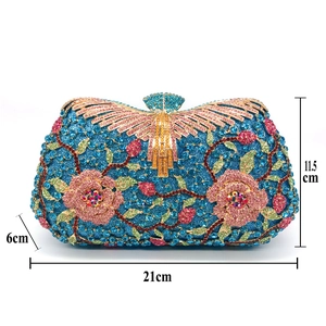 Detailed view of rhinestone floral evening clutch with blue glitter base and metal clasp