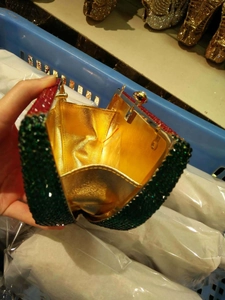 Macro view of crystal evening bag interior with gold leather lining and gemstone clasp