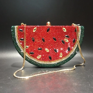 Detail of watermelon crystal clutch showing red and green rhinestones and gold chain
