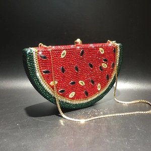 Detailed close-up of watermelon shaped crystal evening bag with sparkling rhinestones