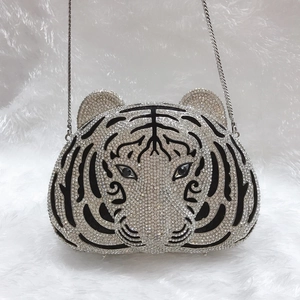 Detailed close-up of tiger head evening clutch bag featuring silver and white rhinestones