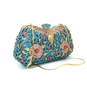 Macro view of crystal rhinestones forming floral patterns on luxury evening clutch bag