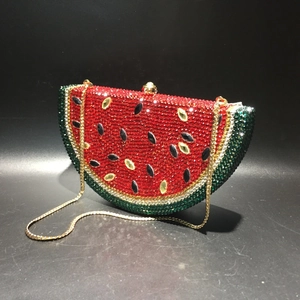 Macro detail of watermelon evening clutch with vibrant red and green rhinestones