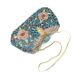 Macro view of crystal floral evening bag with blue rhinestones and butterfly clasp