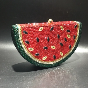 Macro shot of watermelon shaped evening bag with sparkling crystals and golden clasp